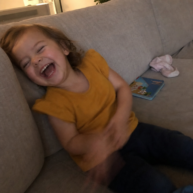 Video still of a toddler belly-laughing